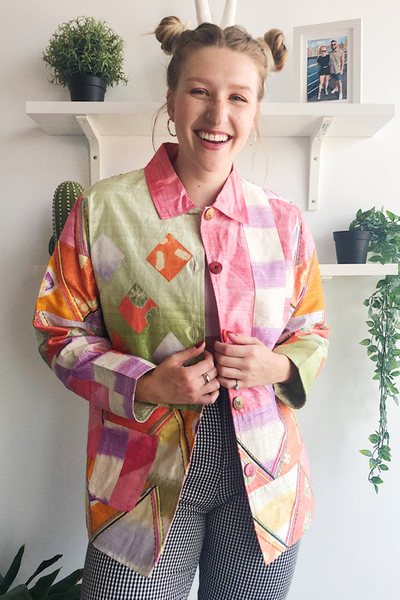 Kate Bauer, 25, a doctoral candidate, an avid thrifter, and a vintage clothing reseller photographed at her home in a thrifted multicolor quilt jacket.