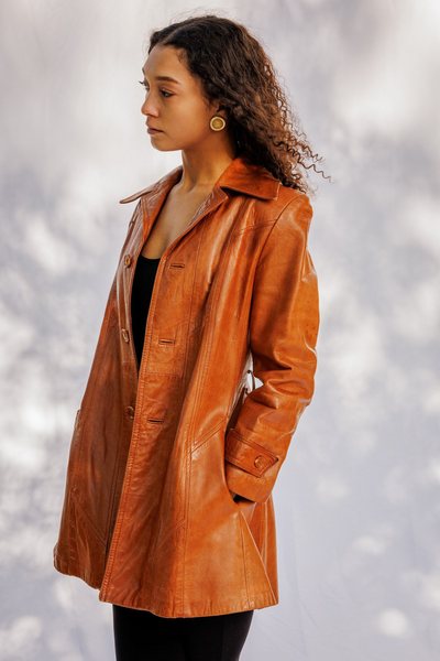 A young woman wearing a brown 70s vintage leather blazer jacket.