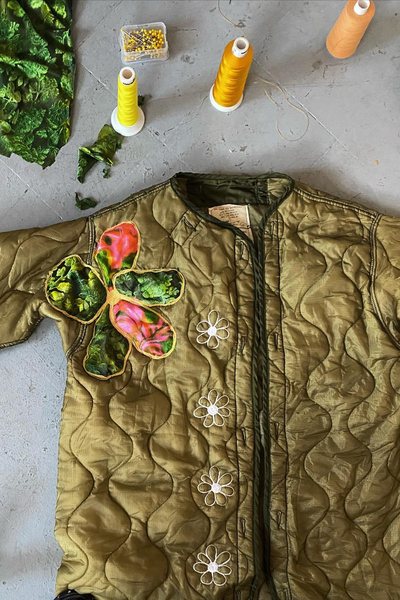 a reworked quilted army jacket on a work table