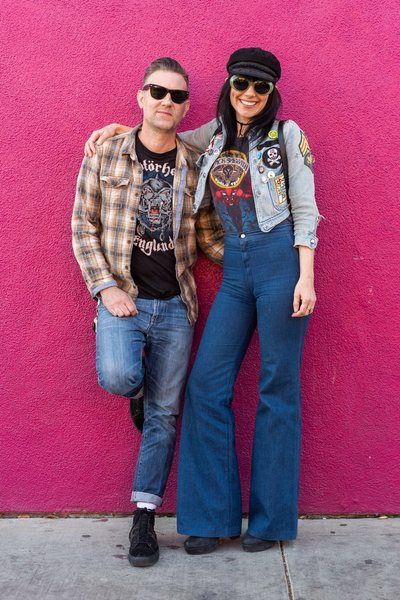 Kerri Barta and Jason Yolkiewicz, the founders of Hellhound Vintage posing in front of a pink wall in Los Angeles.