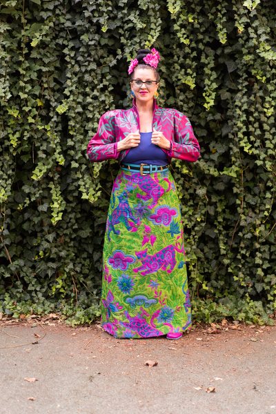 Lana Wharry, 42, wearing a purple printed vintage bolero with a green-and-purple vintage maxi skirt that has animal and floral prints on it