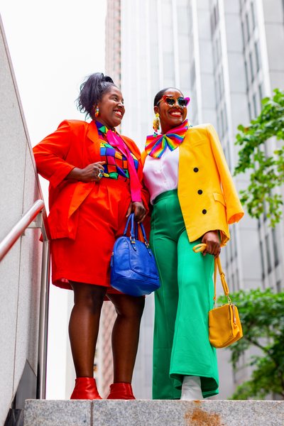 two models wearing primary colored vintage outfits