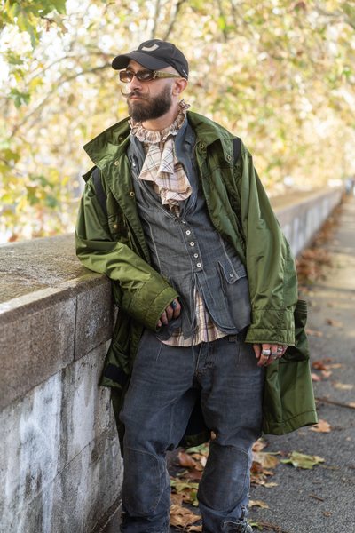 Italian Alessandro Cassano, 27, wearing a green Jean Paul Gaultier parka, Dolce Gabbana multi zip combat jeans from 2003, Ralph Lauren blouse, and a Marithe Francois Girbaud jacket
