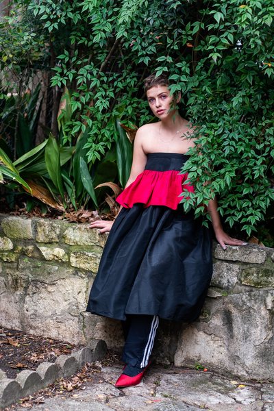 Christhany Zhu wearing a black-and-red vintage 1980s prom dress with black Adidas tracksuit pants and red 1980s pumps