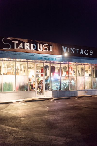 brighly-lit windows of the vintage store Stardust Vintage at night in Austin, Texas