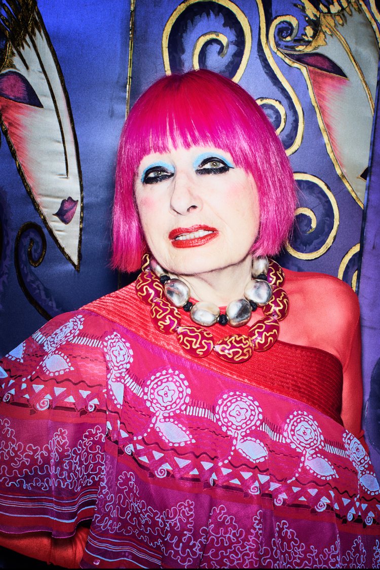 pink haired British fashion designer Zandra Rhodes in one of her own designs, a printed pink caftan and two thick statement necklaces