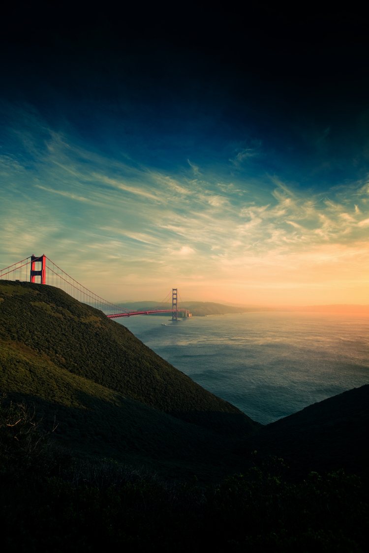 The Golden Gate bridge photographed from the side of Marin county in a dramatic sunrise