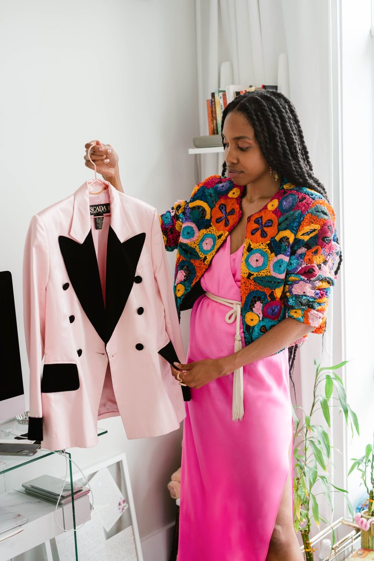 Brownie Brown of High Fashion Thrift holding a pink vintage Escada blazer