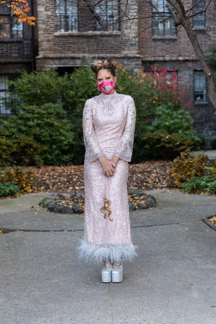 Gisela Castillo, 46, in a long sleeve ankle length pink sequin dress and silver platform shoes.