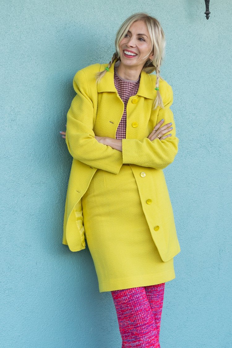 Chelsea von Mach in a bright yellow vintage skirt suit worn over pink knit pants