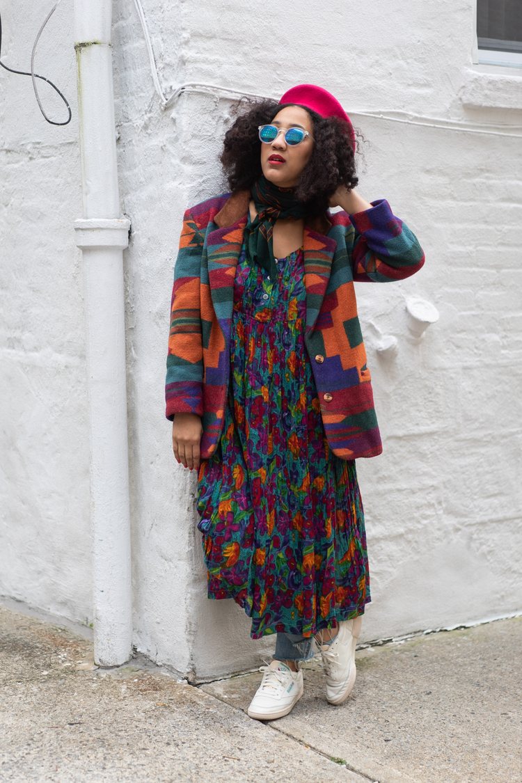 Vintage fashion blogger Leigh Ray wearing a pink beret, sunglasses, a western style colorful wool blazer over a flowy maxi dress in similar colors and blue jeans