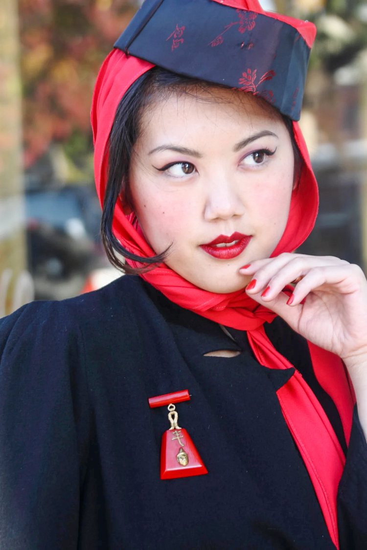 a young woman wearing vintage clothes and Large cherry red bakelite bar brooch, Asian themed from the Art Deco era